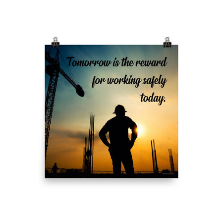 A safety poster showing a worker on a construction site being silhouetted by a sunset of orange and blue colors with the slogan tomorrow is the reward for working safely today.