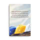 A workplace safety poster showing 3 multi colored hardhats sitting on a wall with the slogan safety isn't something you postpone for the ideal and comfortable future. It's the first condition necessary for the messy and unpredictable present.