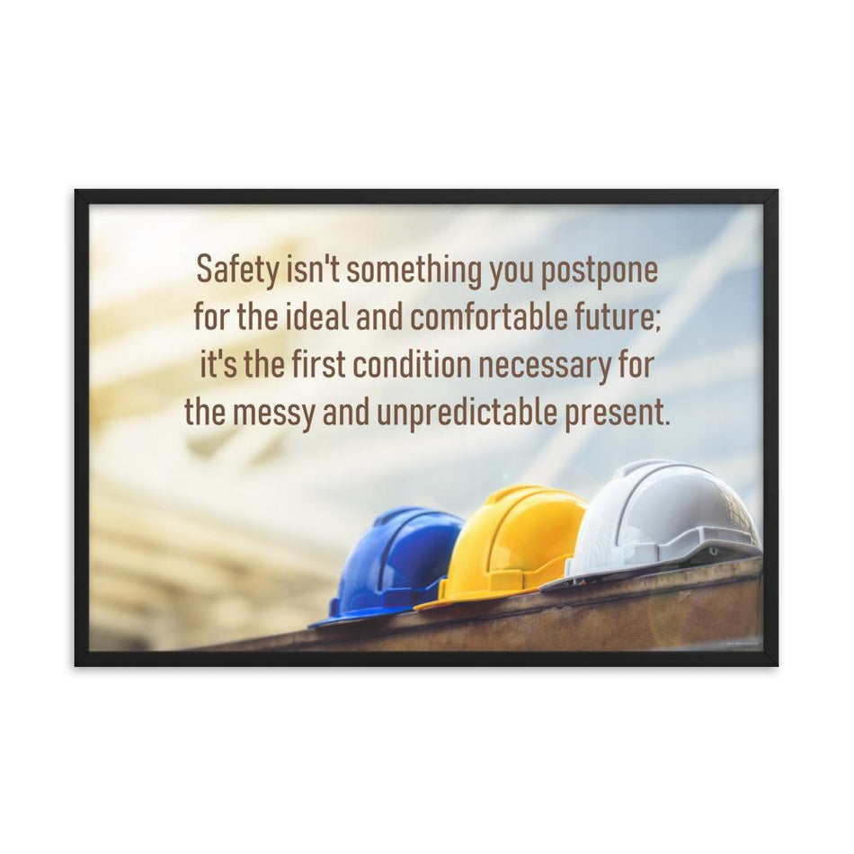 A workplace safety poster showing 3 multi colored hardhats sitting on a wall with the slogan safety isn't something you postpone for the ideal and comfortable future. It's the first condition necessary for the messy and unpredictable present.
