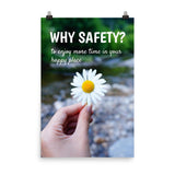 A workplace safety poster showing a close up of a hand holding a bright white daisy in the forest with the slogan why safety? to enjoy more time in your happy place.