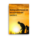 A workplace safety poster showing a construction site and construction workers being silhouetted by a bright and beautiful sunset of different shades of orange with the slogan working safely may get old, but so do those who practice it.