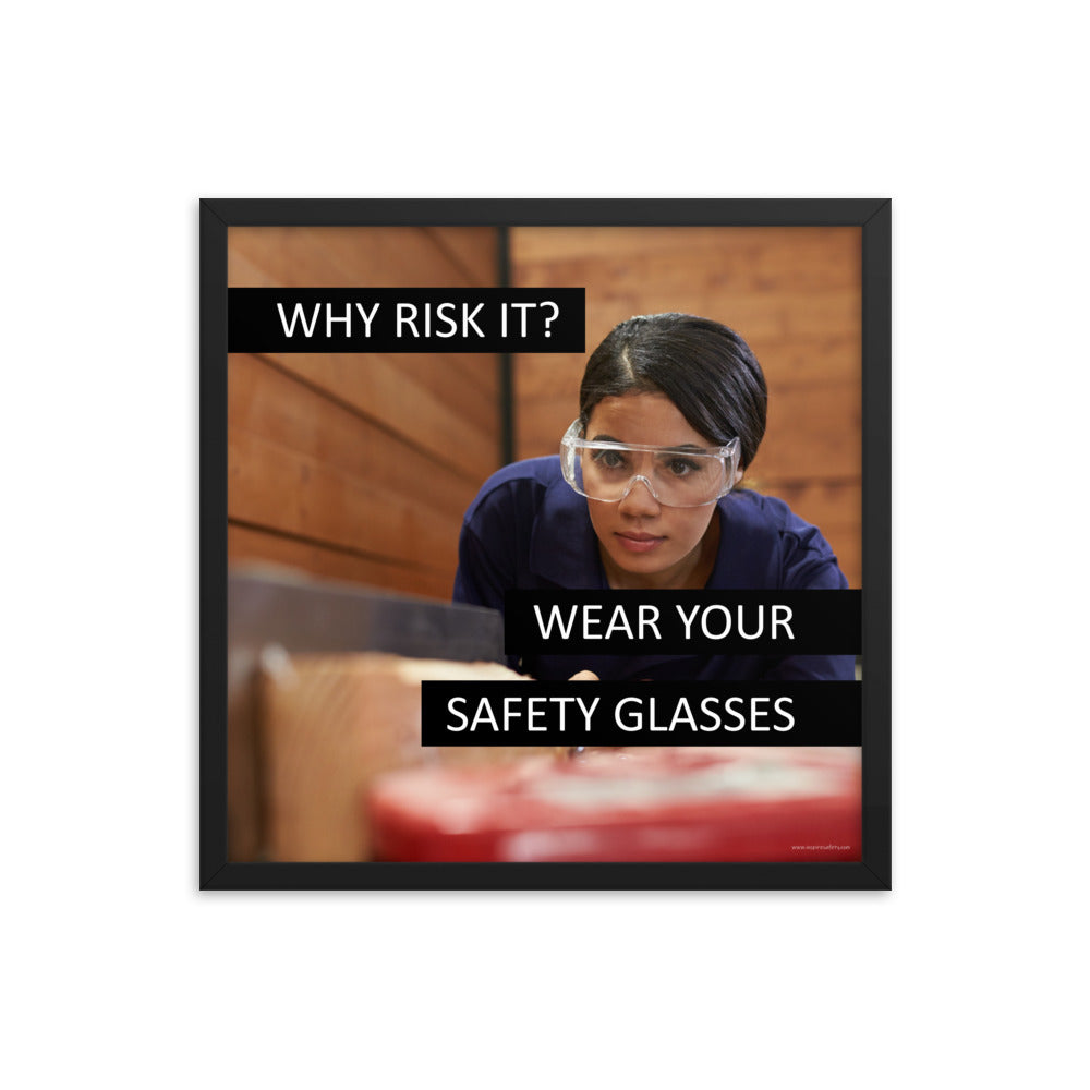 A safety poster showing a woman using a table saw to cut wood wearing safety glasses with the slogan "Why Risk It? Wear Your Safety Glasses."