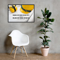 A safety poster showing a yellow hard hat and yellow ear muffs on blueprints with a safety quote by Johann Wolfgang von Goethe that says "Knowing is not enough, we must apply. Willing is not enough, we must do."