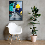 A safety poster showing a man in a yellow hard hat, red earmuffs and safety glasses, working in a factory with the slogan "HOw you do anything is how you do everything" below him.
