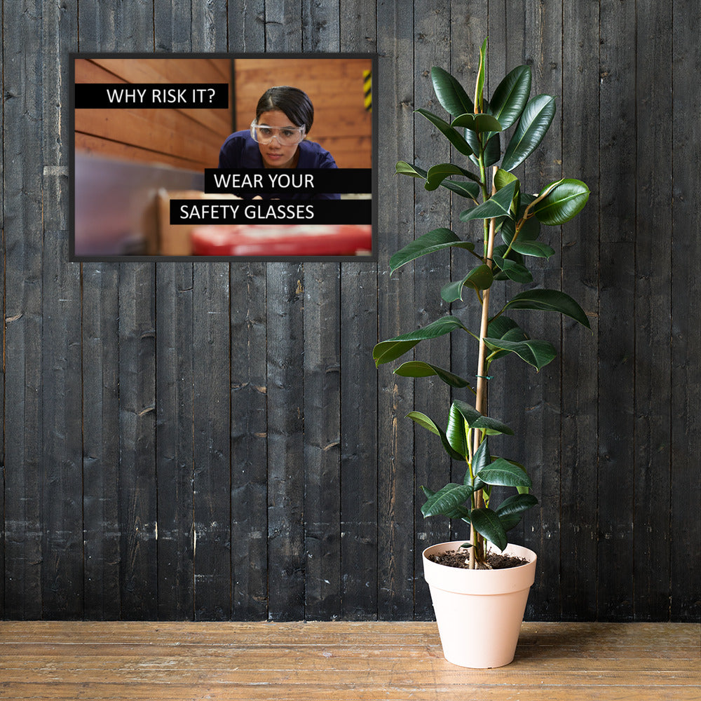 A safety poster showing a woman using a table saw to cut wood wearing safety glasses with the slogan "Why Risk It? Wear Your Safety Glasses."