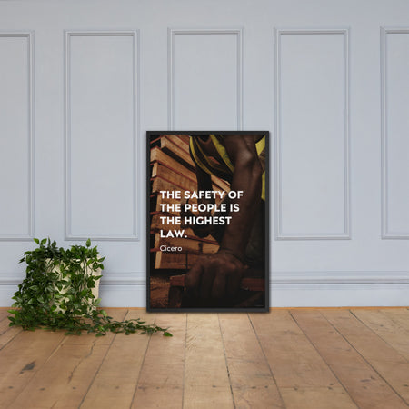 A safety poster of a construction worker in a hi-visibility vest hammering a nail into wood with a safety quote by Cicero that says "The safety of the people is the highest law."