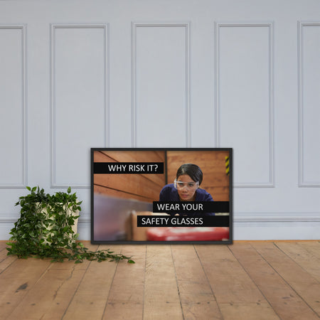 A safety poster showing a woman using a table saw to cut wood wearing safety glasses with the slogan "Why Risk It? Wear Your Safety Glasses."