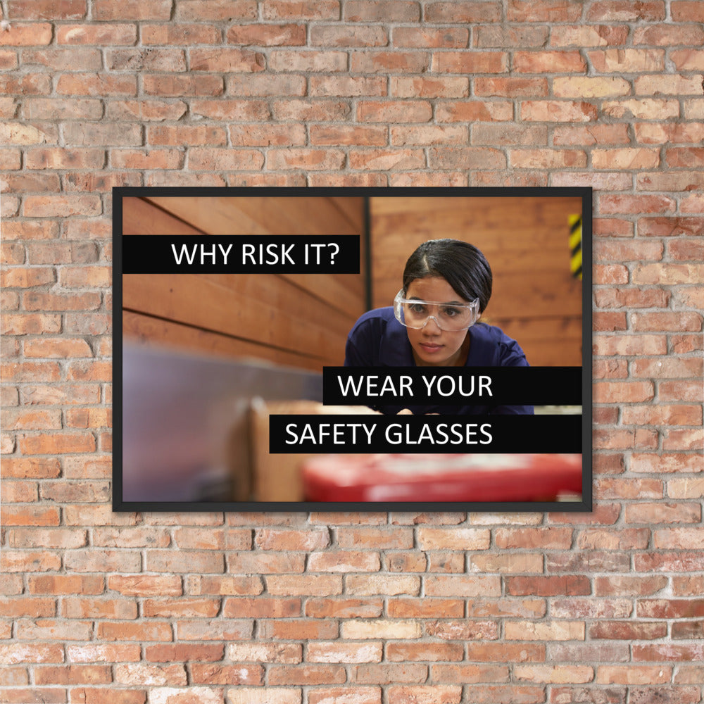 A safety poster showing a woman using a table saw to cut wood wearing safety glasses with the slogan "Why Risk It? Wear Your Safety Glasses."