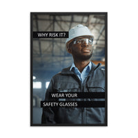 An eye safety poster showing a man in a white hard hat and safety glasses in a warehouse with the slogan "Why risk it? Wear your safety glasses."
