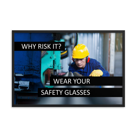 A safety poster showing a worker in a hard hat, ear muffs, safety glasses, and gloves with the slogan "Why Risk It? Wear Your Safety Glasses."