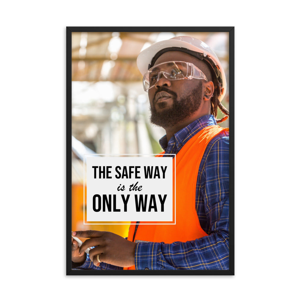 A construction worker in an orange vest, hard hat, and safety glasses working intently with the slogan "The safe way is the only way."