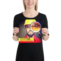 An eye safety poster showing a close up of a man's face wearing safety glasses and a yellow hard hat with a magnifying glass focusing on the right eye with an eye safety slogan underneath him.