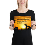 A workplace safety poster showing a construction site and construction workers being silhouetted by a bright and beautiful sunset of different shades of orange with the slogan working safely may get old, but so do those who practice it.