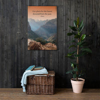 A safety poster showing a landscape of burnt orange tinted mountains with the sunlight piercing through the tops of the mountains with the quote our plans for the future descend from the past by Seneca.