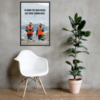 A safety poster showing two workers in reflective vests collaborating on a construction site with the proverb to know the road ahead ask those coming back.