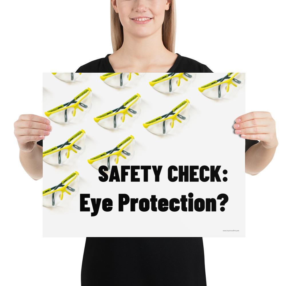 An eye safety poster depicting many clear safety glasses with yellow trim neatly lined up in rows and rows with a safety slogan in the foreground.