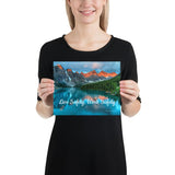 A workplace safety poster depicting a beautiful landscape of mountains with a river flowing down the side of the mountains into a bright blue pond with text saying live safely work safely.