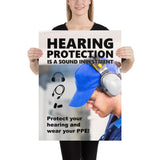 An ear safety poster showing a close up of a man's profile wearing ear muffs and safety glasses with a safety slogan and infographics of hearing PPE all around him.