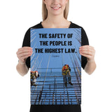 A safety poster showing construction workers scaling rebar with a bright blue sky as the background and a safety quote in black block text.