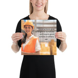 Safety poster showing a female warehouse worker smiling and wearing an orange reflective safety vest and orange hard hat with a safety quote written in dark text.