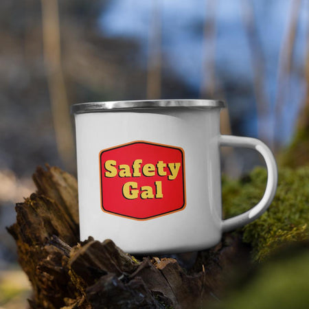 White metal mug with a silver rim with a red emblem encasing bold yellow text that says "Safety Gal."