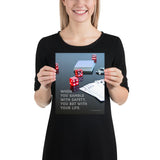 A workplace safety poster of a glossy black table with red dice, playing cards, and poker chips strewn everywhere with a safety slogan in the bottom left corner.