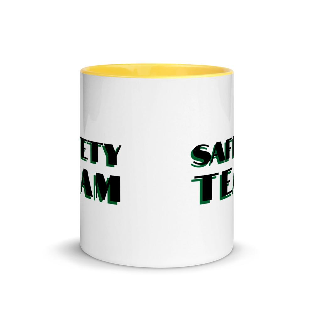 White ceramic mug with "Safety Team" in bold text across the side, with yellow color on the inside, the rim, and the handle.