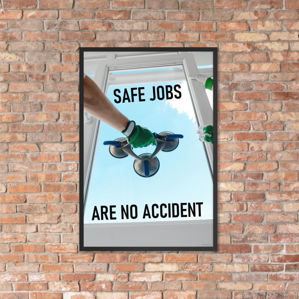 A workplace safety poster showing a close-up of two worker's hands wearing gloves while installing windows with the slogan safe jobs are no accident.