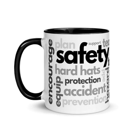 White ceramic mug with safety terms like hard hats, protection, and encourage, in a various shades of black and grey across the mug with a black rim, inside, and handle.