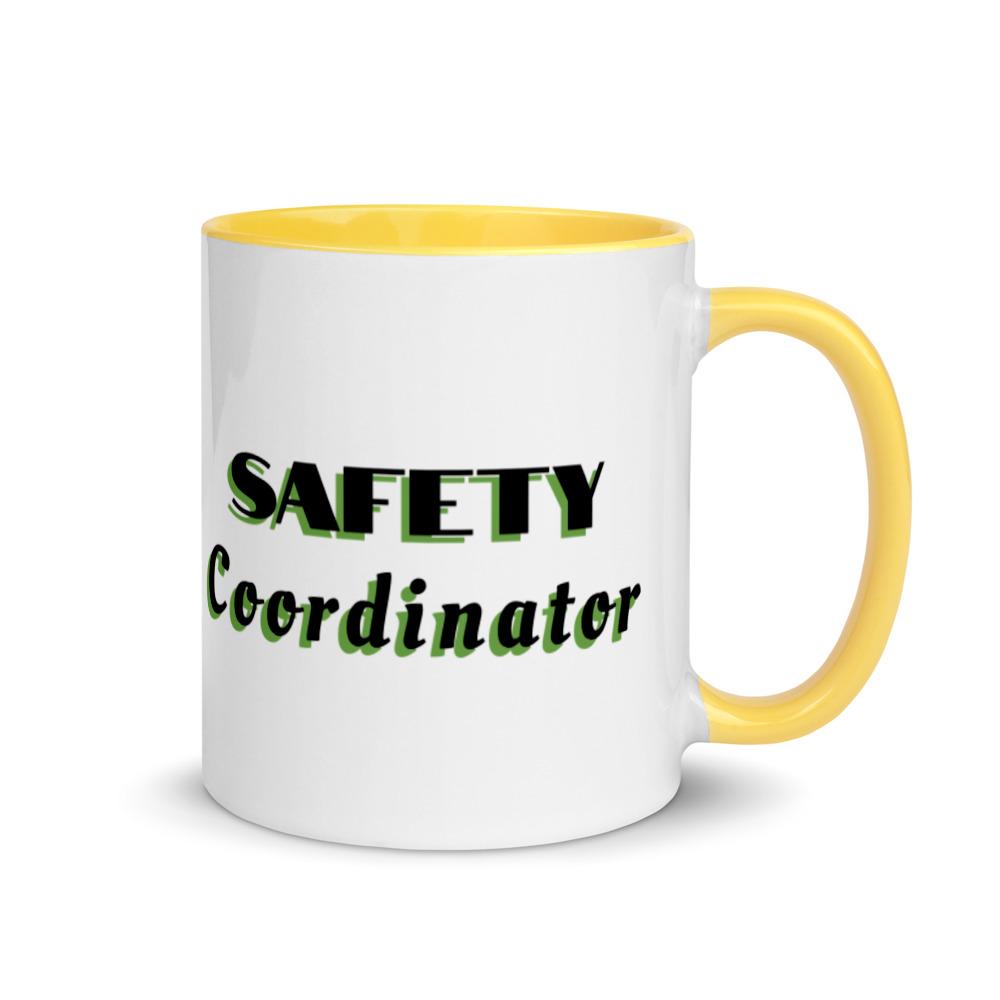 White ceramic mug with "Safety Coordinator" in bold text across the side, with yellow color on the inside, the rim, and the handle.