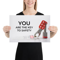 A workplace safety poster showing a lockout tagout lock and tag with the text you are the key to safety.