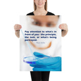 Safety poster showing a close up of a woman's face wearing safety glasses and a white face mask, holding a petri dish and pipette with a safety quote written in blue text.