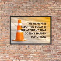 A workplace safety poster showing an orange safety cone with the slogan the near miss reported today is the accident that doesn't happen tomorrow.