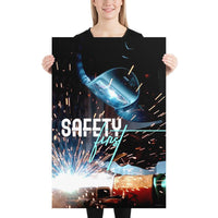 A safety poster showing a close-up of a welder welding a pipe while wearing a welding hood with bright sparks flying all around with the slogan safety first.