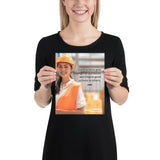 Safety poster showing a female warehouse worker smiling and wearing an orange reflective safety vest and orange hard hat with a safety quote written in dark text.
