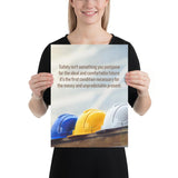 A workplace safety poster showing 3 multi colored hardhats sitting on a wall with the slogan safety isn't something you postpone for the ideal and comfortable future. It's the first condition necessary for the messy and unpredictable present.