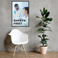 A safety poster showing two lab workers collaborating on a project in a lab while wearing full PPE with the slogan safety first.
