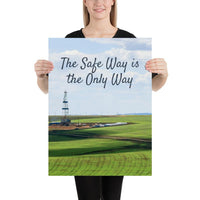 A safety poster showing an oil rig in a beautiful landscape scene of a field with vivid green grass and a bright blue sky with the slogan the safe way is the only way.