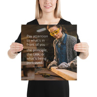 Workplace safety poster of a young female woodworker wearing safety glasses and gloves and sanding a two by four in her shop with a safety quote to the left.