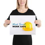 A safety poster showing a close-up of a yellow hard hat on a white background with the slogan work smart and work safe.