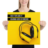 A hearing protection safety poster depicting bright yellow ear muffs on a bright yellow background in the bottom right corner with a bold safety slogan in the upper left corner.