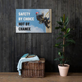 A fully harnessed man wearing a hard hat scaling the side of a building with a bright blue sky and clouds in the background with the text safety by choice, not by chance in bold text to his left.