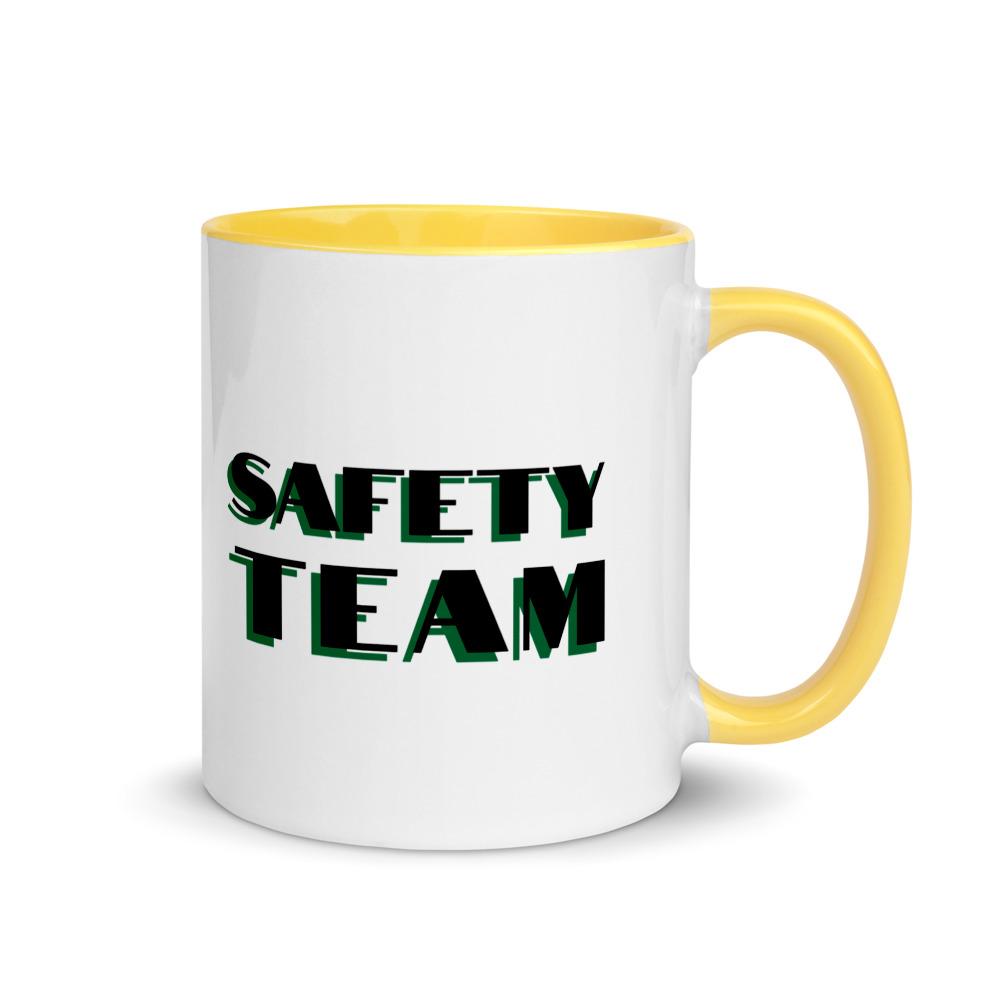 White ceramic mug with "Safety Team" in bold text across the side, with yellow color on the inside, the rim, and the handle.