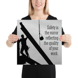 A workplace safety poster showing a construction ironworker working on a construction site with everything silhouetted black with a light grey background and with the slogan safety is the mirror reflecting the quality of your work.