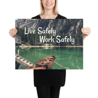 A workplace safety poster depicting a beautiful landscape of mountains in the background of a lake with a little wooden boat in the lake with text saying live safely work safely.