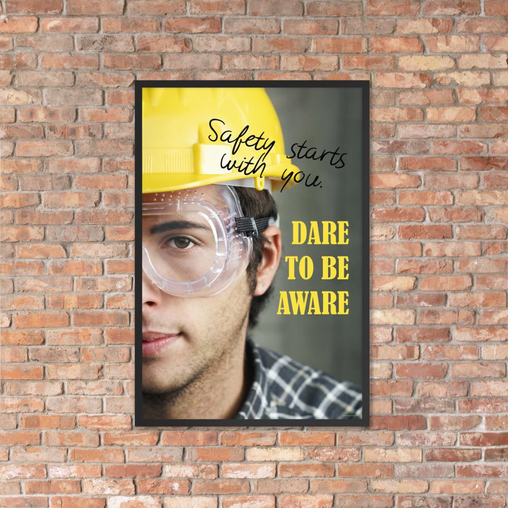 Safety poster showing a close up on half of a man's face wearing a yellow hard hat and safety glasses with text to the right.