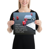A workplace safety poster of a glossy black table with red dice, playing cards, and poker chips strewn everywhere with a safety slogan in the bottom left corner.