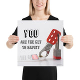 A workplace safety poster showing a lockout tagout lock and tag with the text you are the key to safety.