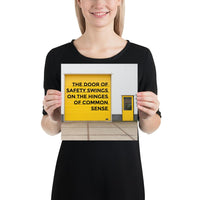 Workplace safety poster depicting a bright yellow garage door to a warehouse with a bold safety slogan on it with a smaller yellow door to the right.