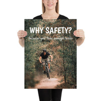 A workplace safety poster showing a man dirt biking on a forest trail with the slogan why safety? because you take enough risks.